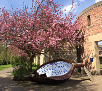 Henshaws Arts and Crafts Centre Entrance with a pink blossom tree outside