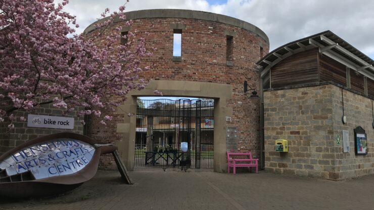 Arts and Crafts Centre Entrance Rotunda next to a pink blossom tree