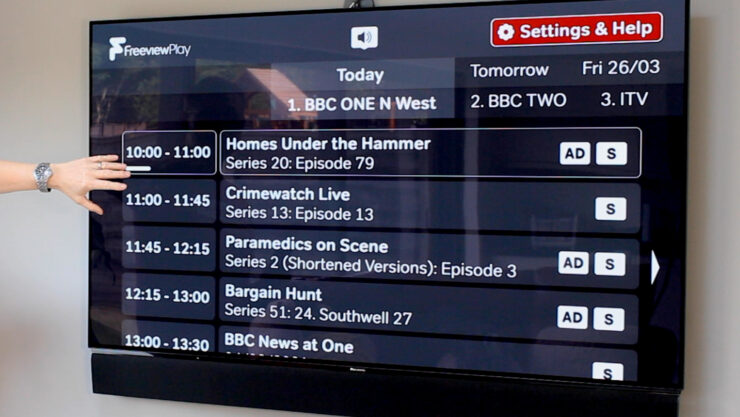 Accessible TV guide on screen, showing white text on black background
