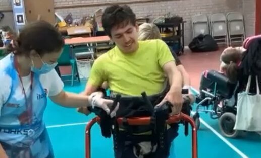 Student Patrick using a special support to move around without his wheelchair