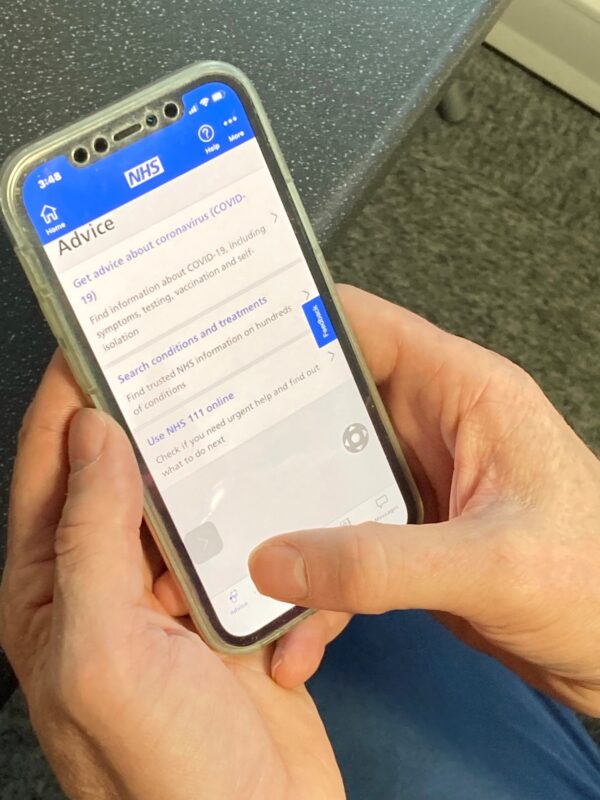 Close up image of the NHS app on a phone