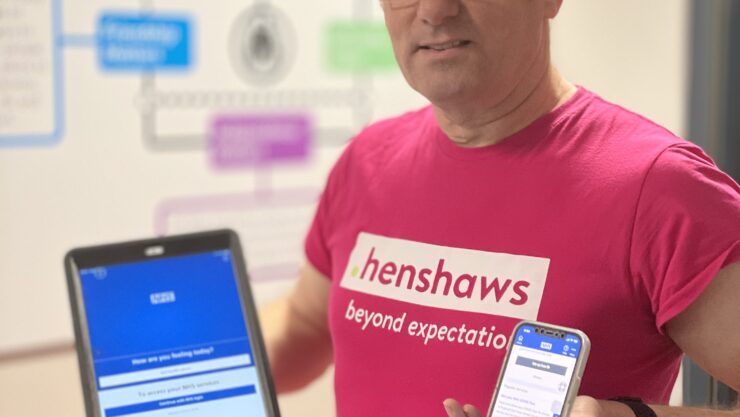 Richard with a mobile and tablet with the NHS app uploaded