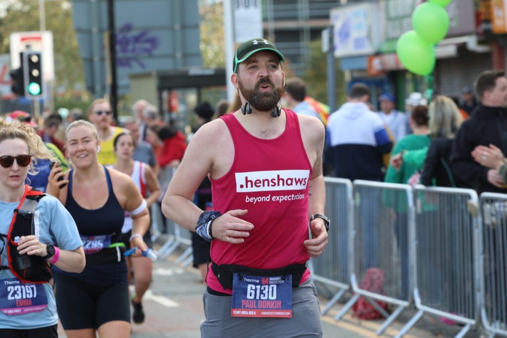 A man running in a Henshaws T Shirt