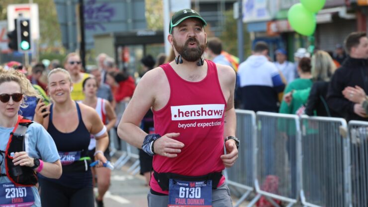 A man running in a Henshaws T Shirt