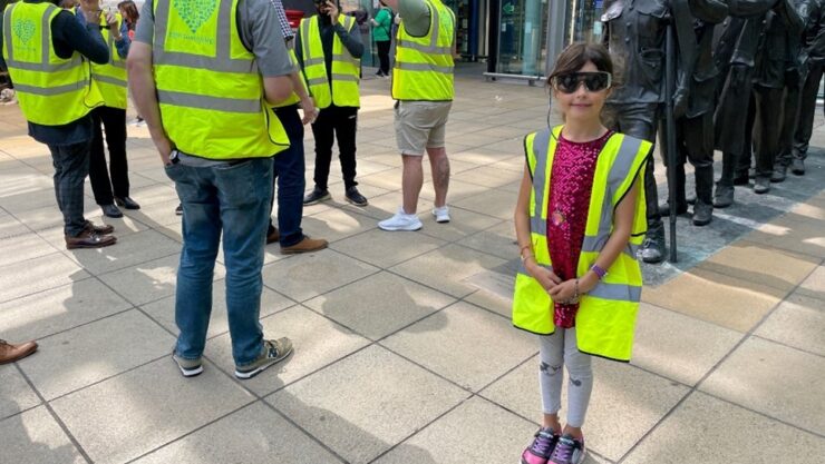 The Project Team and a Henshaws volunteer outside Manchester Piccadilly Train Station, wearing Sight Loss simulation glasses and Hi-Viz jackets Getting ready for their Visual Impairment Awareness Training.