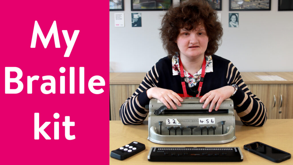 Alice sat at a desk with a Perkins Brailler in front of her. In front of the Perkins Brailler, from left to right, are the Hable One, a refreshable Braille display and an iPhone. To the left of the image is the text "My Braille Kit" on a pink background.