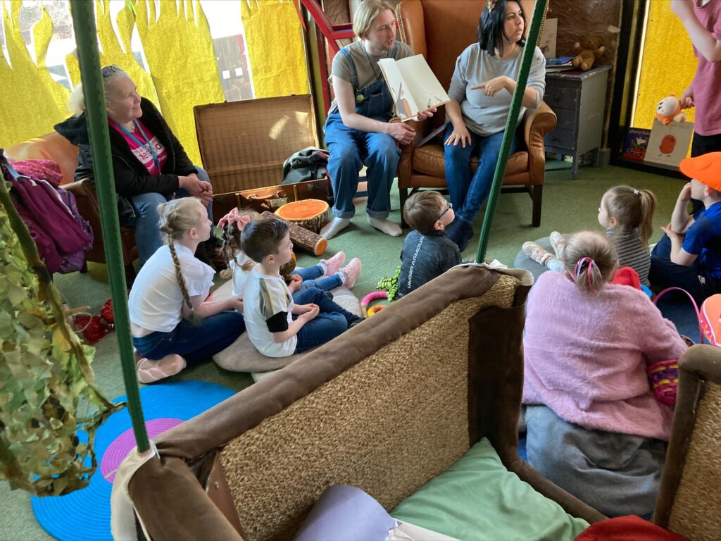 Children and adults sat together at Storybarn in Liverpool enjoying time together